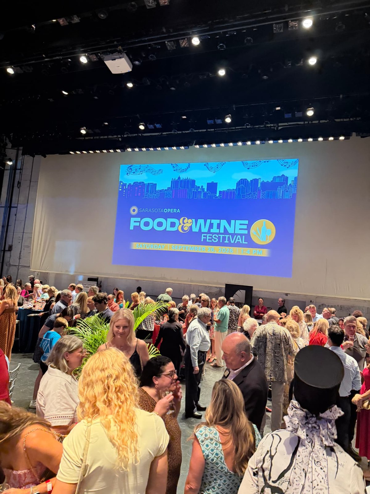 Guests gather beneath the Sarasota Opera Food and Wine Festival 2026 screen at Sarasota Opera House