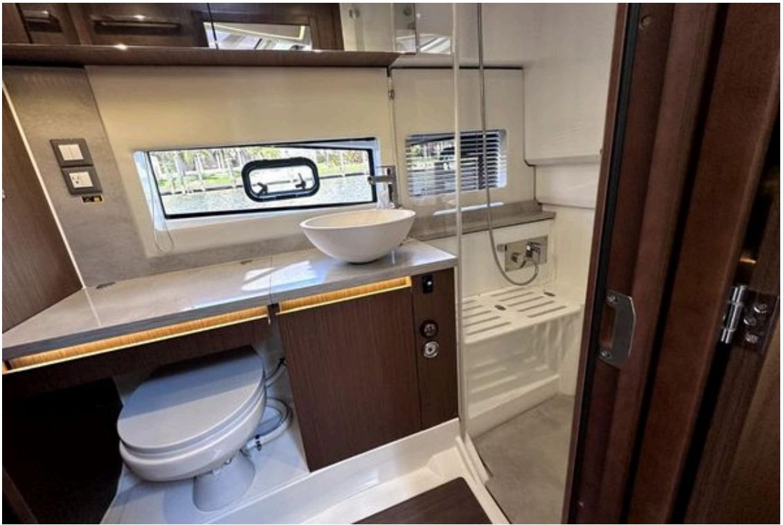 Interior galley with light cabinetry and dining area